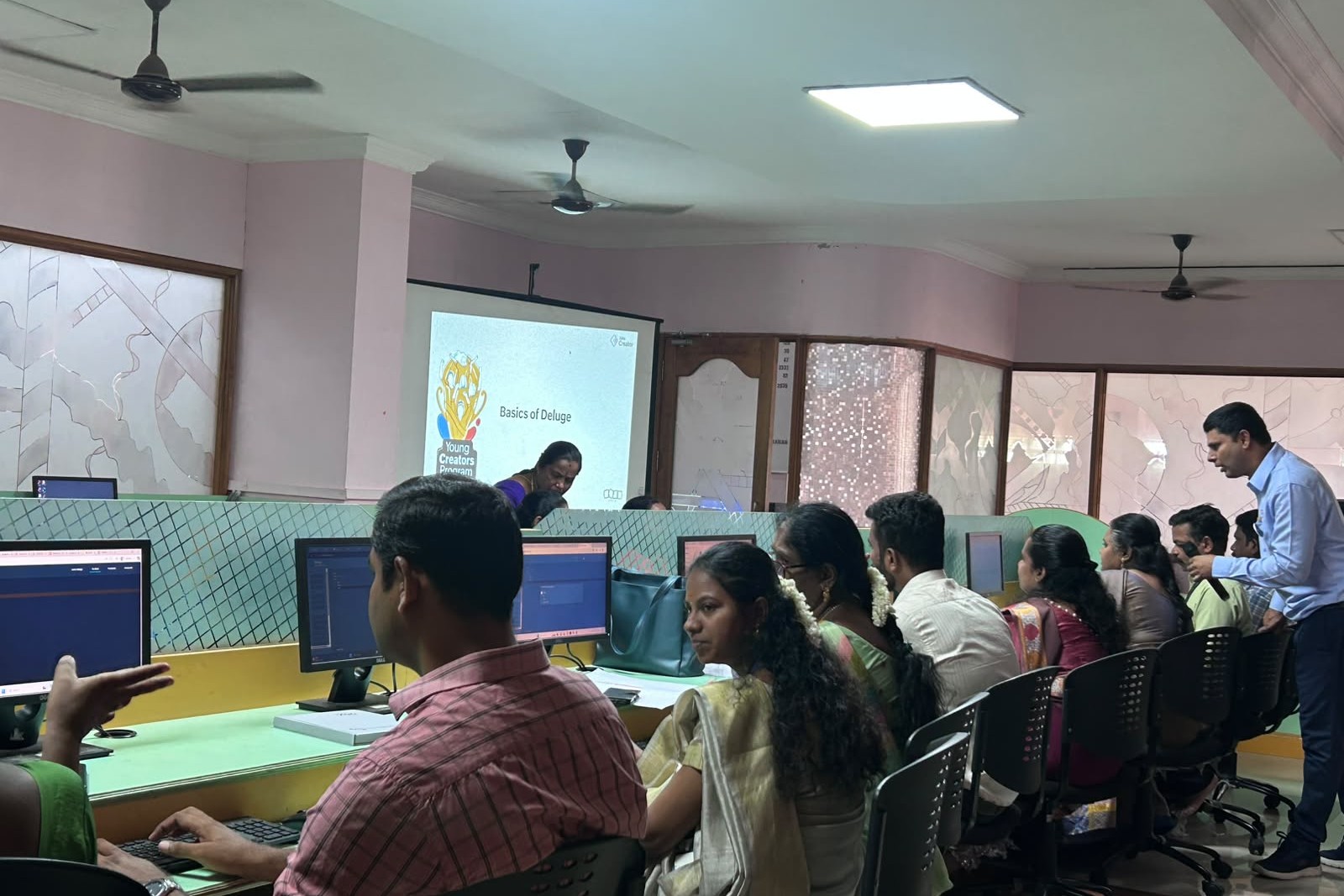Faculty members attending Zoho Creator training session